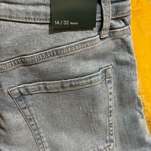 Never worn with tags. Highest rise Distressed Straight Leg Blue Jeans.